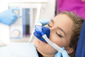 Girl with nitrous oxide sedation dentistry mask in dental chair