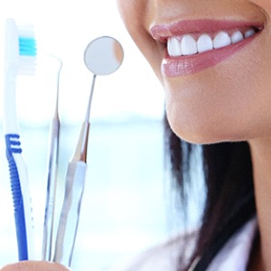 Closeup of smile dental tools used to treat gum disease