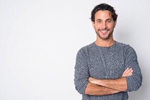smiling handsome man with his arms folded