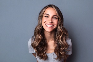 woman smiling after understanding the cost of cosmetic dentistry in Lincoln