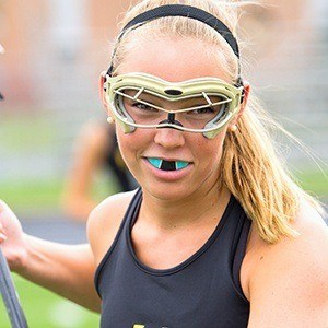 Teen girl placing laCrosse with sportsguard