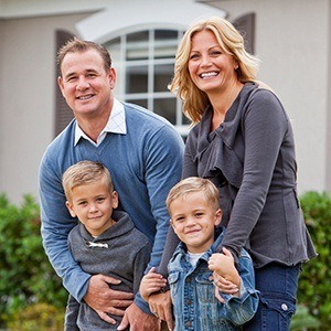 Smiling family outdoors after preventive dentistry