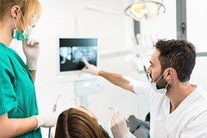 Dentist looking at x-rays during dental checkup