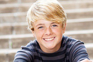 Teen boy on stairs after children's dentistry