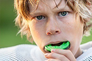 Young athlete placing sportsguard