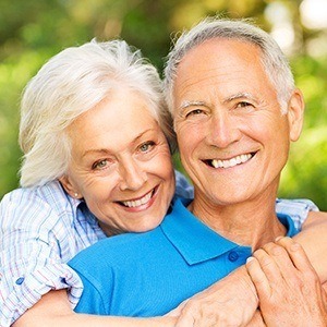 Senior couple smiling together after restorative dentistry