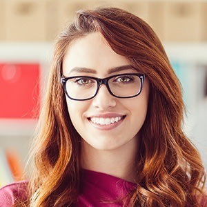 Woman with gorgeous smile after porcelain veneer treatment