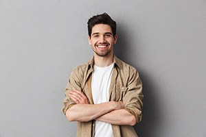 smiling man with his arms folded