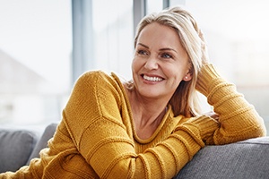 smiling middle-aged woman sitting on a couch