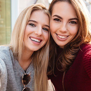 Two women with gorgeous smiles after cosmetic dentistry