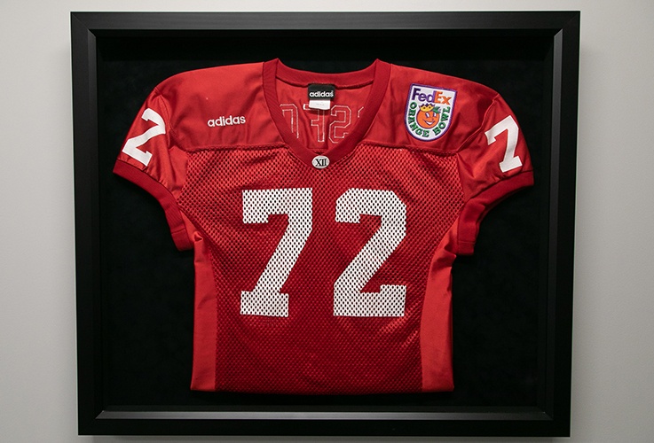 Football jersey framed on dental office wall