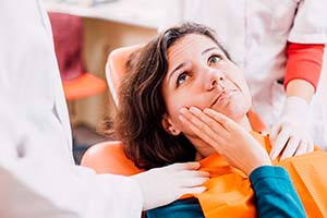 Woman with toothache visiting her Lincoln emergency dentist