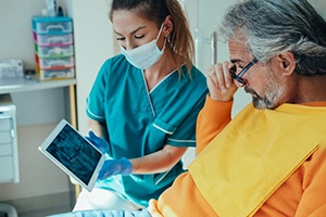 patient looking at X-rays and talking about tooth extractions (for factors section)