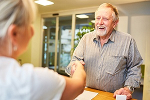 shaking hands after using dental insurance for tooth extractions