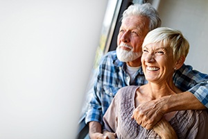 older couple smiling with dental implants in Lincoln