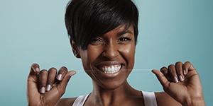 woman flossing and doing an oral hygiene routine