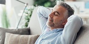 man resting after getting dental implants in Lincoln