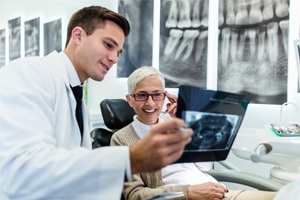 Dentist and patient discussing the dental implant retained denture procedure