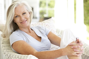 Woman smiling after dental implant salvage