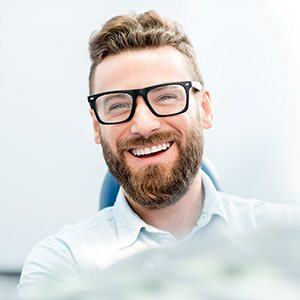 Smiling man in dental chair for dental cleanings