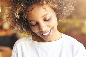 Woman with flawless smile after porcelain veneer placement