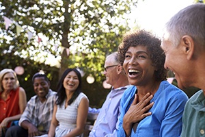 Diverse group of friends with dental implants in Lincoln laughing together