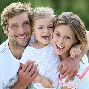 Mother father and daughter smiling after preventive dentistry visit