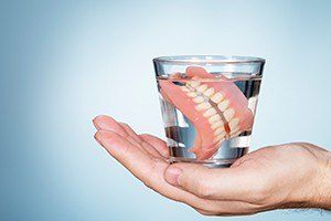 Full denture in a glass of water