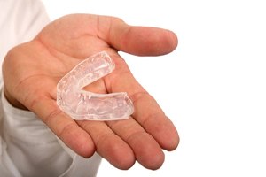 dentist holding mouthguard in Lincoln