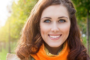 Young woman with picture-perfect smile after porcelain veneer treatment