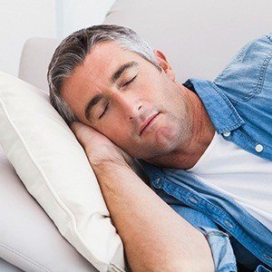 Man sleeping soundly with protective nightguard for bruxism