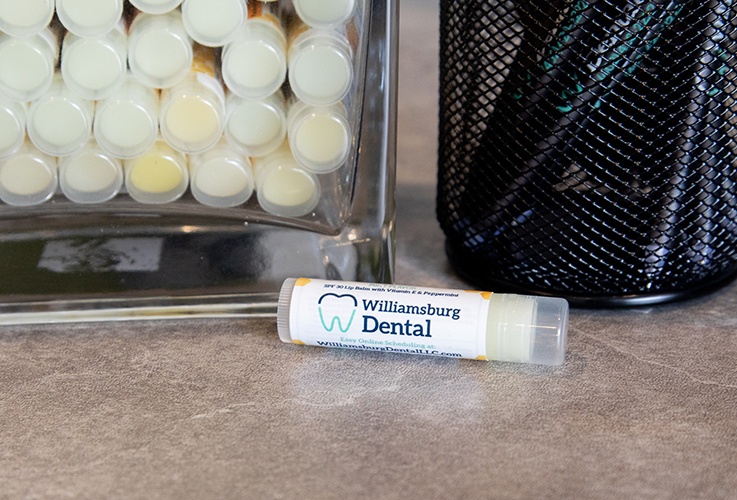 Closeup of lip balm with Williamsburg Dental branding