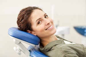 A woman lying back in a dentist’s chair and preparing to undergo a screening for oral cancer in Lincoln