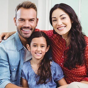 Mother father and daughter smiling after preventive dentistry visit