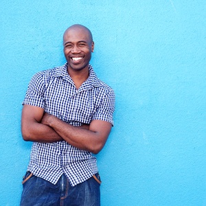 Man with all porcelain dental crowns smiling