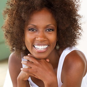 A woman with porcelain veneers smiling