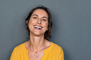 woman smiling after full-mouth reconstruction