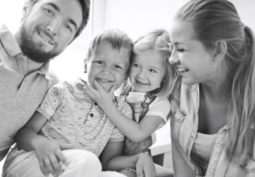Family of four with healthy smiles thanks to affordable dental membership club plan