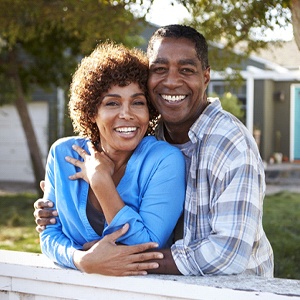 smiling couple with attractive teeth after smile makeover