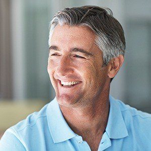 Man with healthy smile after dental implant tooth replacement