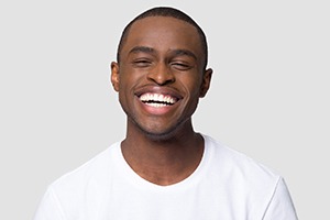 man smiling after getting veneers in Lincoln