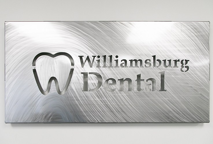 Metal sign with Williamsburg Dental logo