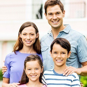 Smiling family outdoors after preventive dentistry