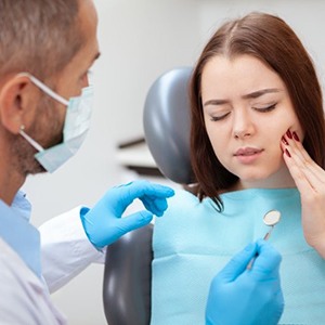 Young woman with back tooth pain before wisdom tooth extraction