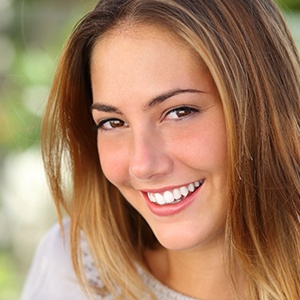 young adult woman smiling after wisdom teeth removal
