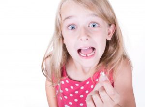 young girl missing tooth