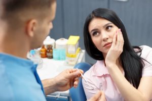 A dentist talking to a patient.