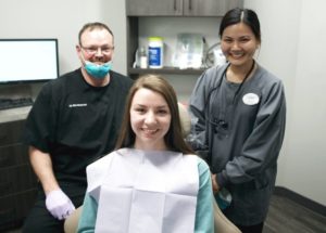 Dr. Gessford and hygienist Quynh with a patient