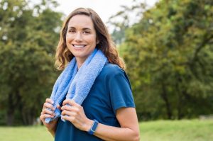 A woman holding a towel outside.