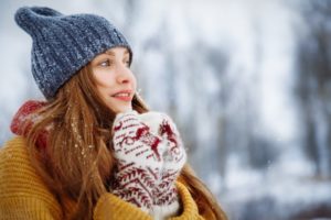 woman out in the cold with winter mouth issues